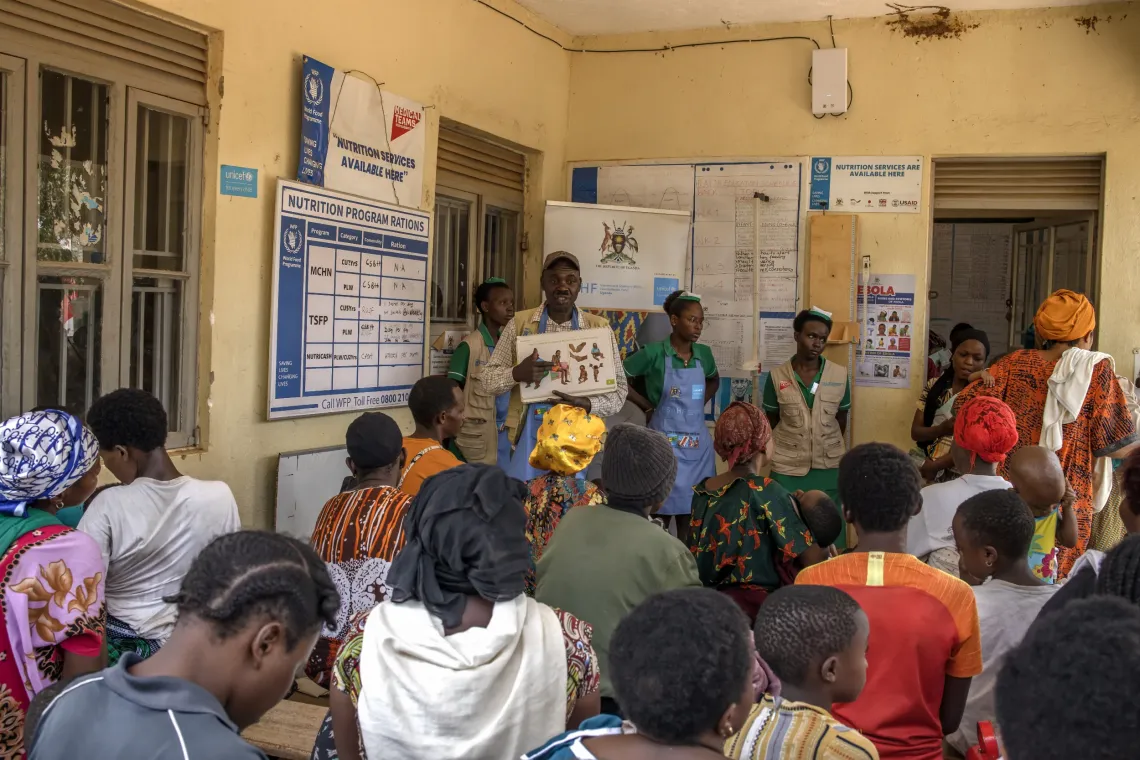 Albert Mwizerwa, 52, a health educator at Nyarugugu Health Centre III, conducts a nutrition education and sensitization session for caregivers who have come to the facility for nutrition services in Nakivale Refugee Settlement, Isingiro District, Uganda, on September 8, 2026. 
