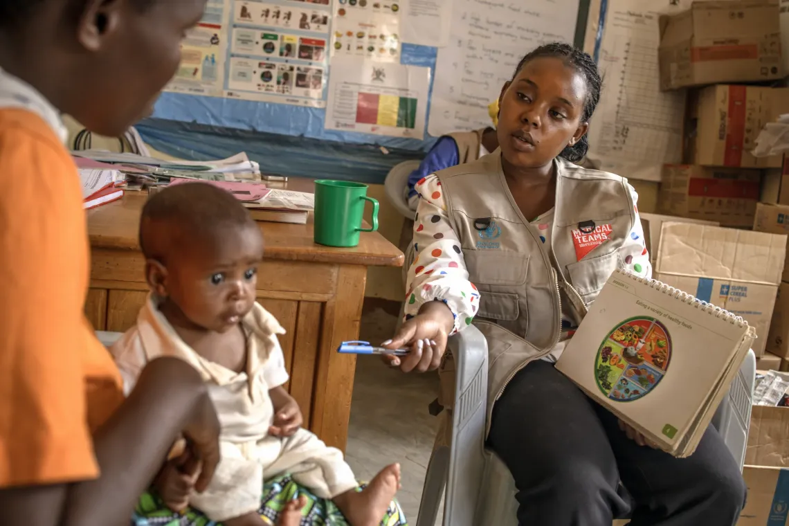 Abi Oworikunda provides nutrition counselling to Sabimana Geraldine, 32, as she holds her 8-month-old daughter, Irasubiza Nina, at Nyarugugu Health Centre III in Nakivale Refugee Settlement, Isingiro District, Uganda, on September 8, 2026.