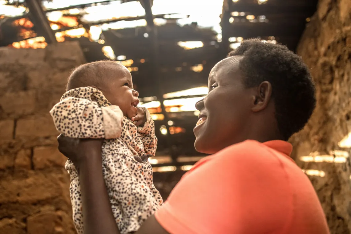 Sabimana Geraldine, 32, shares a light moment with her 8-month-old daughter, Irasubiza Nina, inside their home in Nakivale Refugee Settlement, Isingiro District, Uganda, on September 9, 2026.