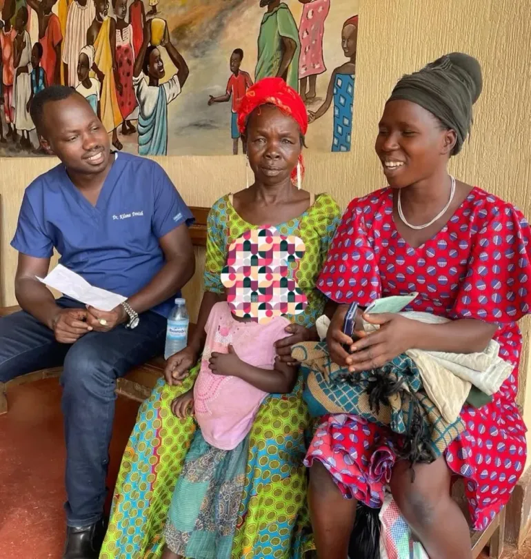 Dr Denish Kilama counsels the caregiver of a young child diagnosed with congenital glaucoma at Yotkom Hospital in Kitgum District. The child&rsquo;s name has been withheld to protect their identity.