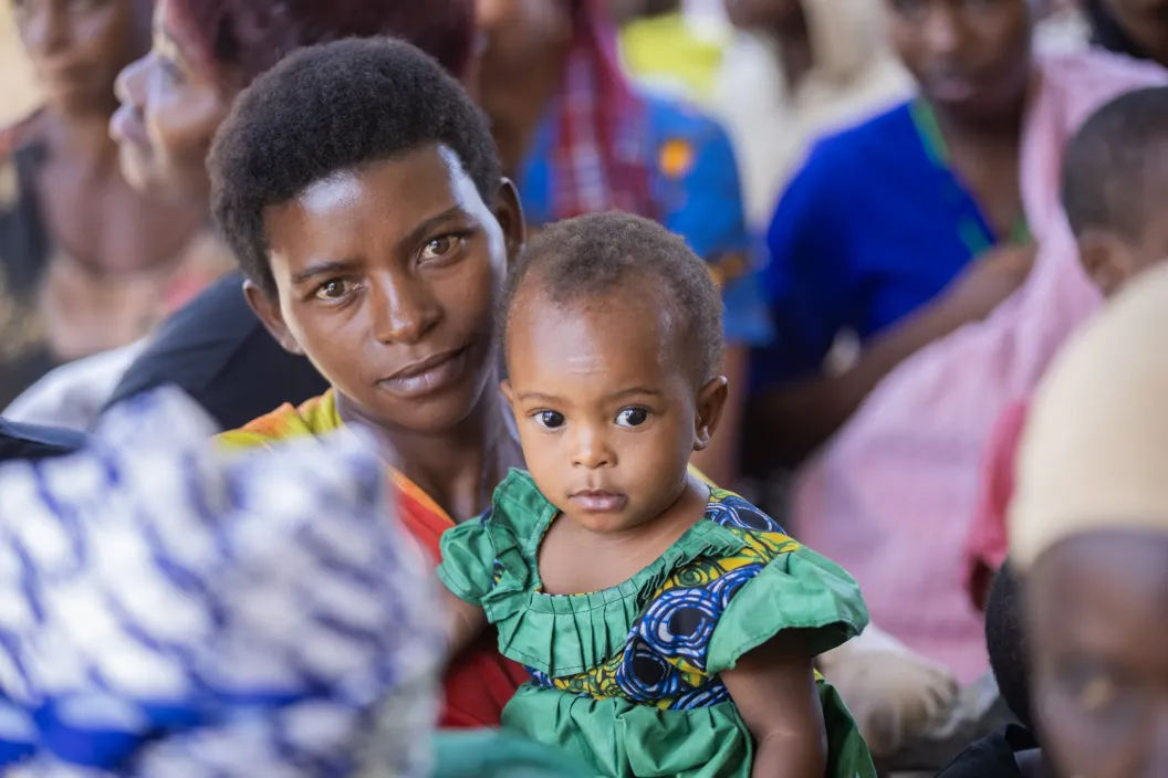 A caregiver with her baby waits in line to receive nutrition services at Nyarugugu Health Centre III in Nakivale Refugee Settlement, Isingiro District, Uganda, on September 8, 2026.