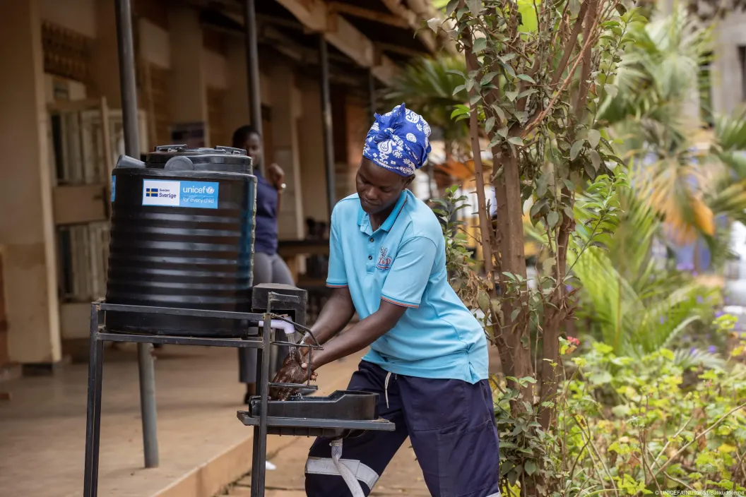 A Kiswa Health Center IV staff member using a handwashing station. UNICEF ensured access to clean water and hygiene facilities in schools, health centres and communities through distributing tap stands, bleach and sanitizer critical to limiting the spread of the Ebola virus.