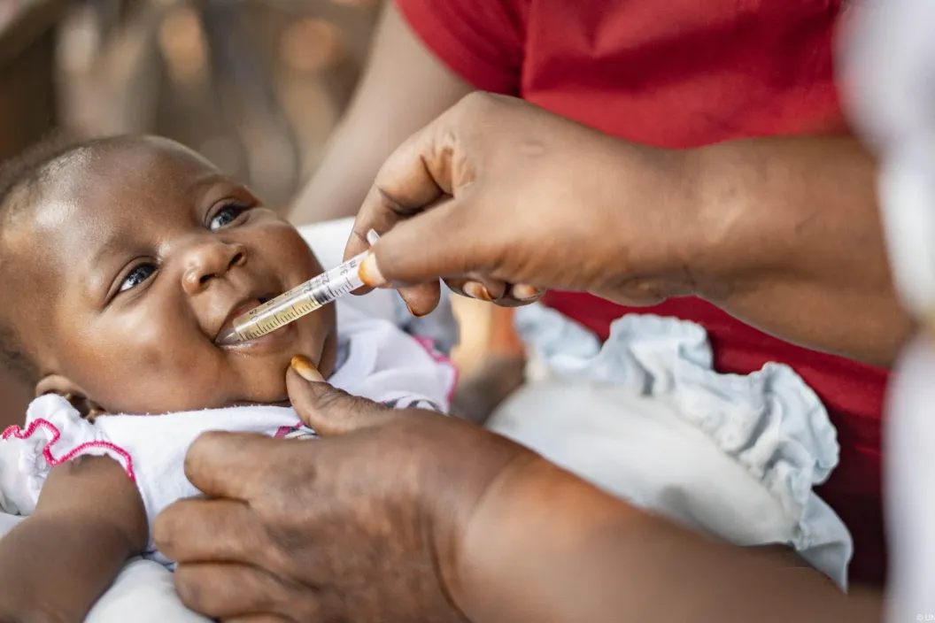 A baby receiving the rotavirus vaccine at Ayer Health Centre III, Kole District, Northern Uganda. The Health Facility Solar Electrification (HFSE) project strengthens immunisation and healthcare delivery at primary health facilities by providing reliable electricity.