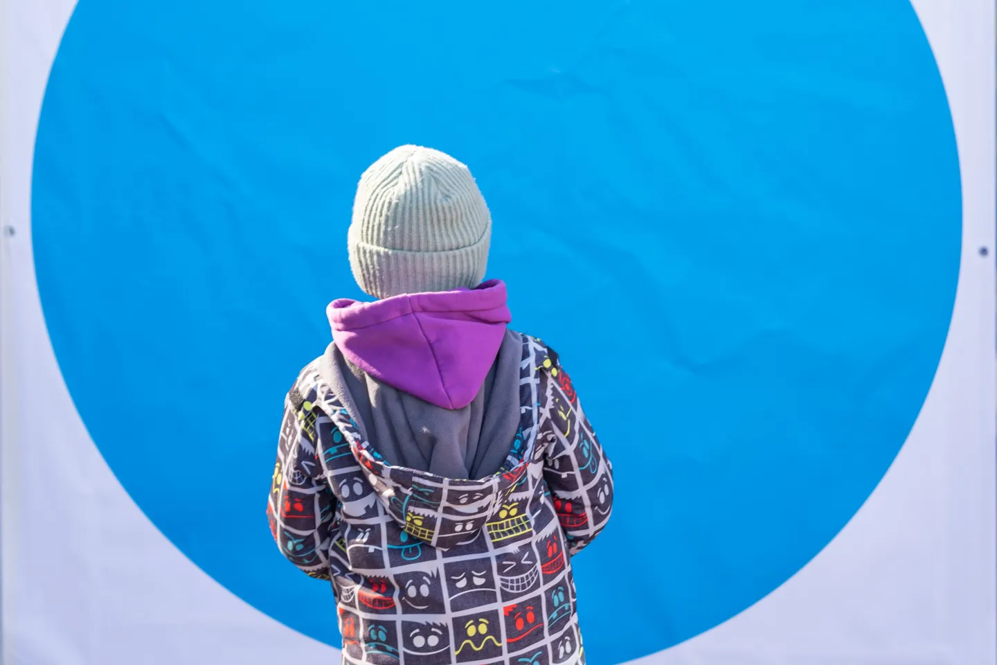 Romania. A child stands outside a Blue Dot hub.