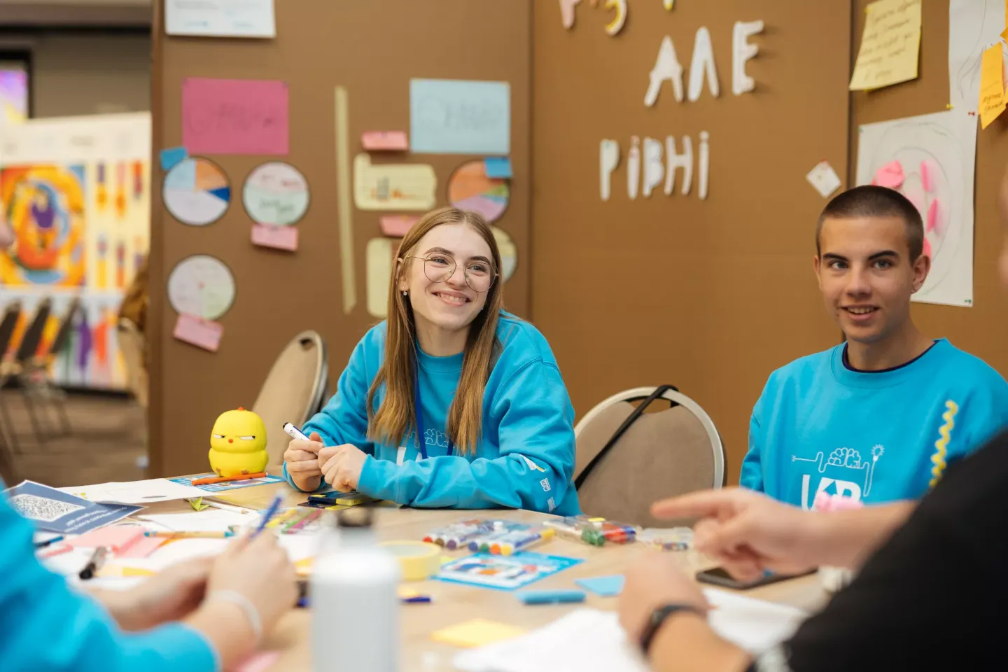Young people sitting at tables during the UPSHIFT event