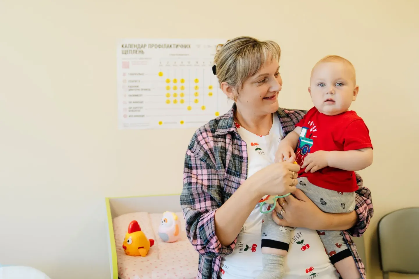 A mother hold her small son while visiting the hospital.