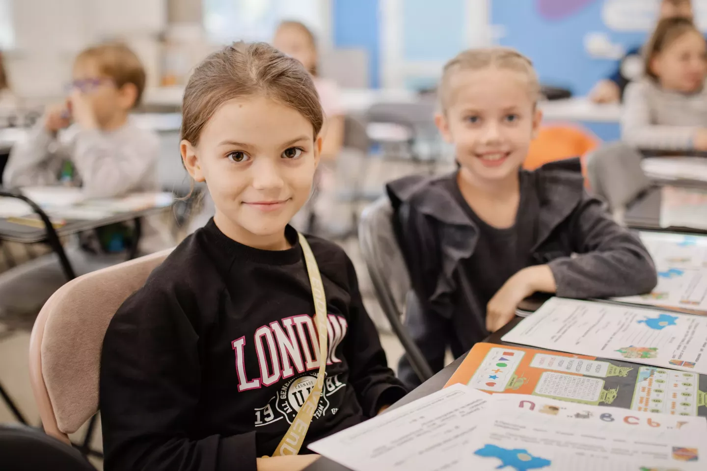Two girls sitting at a desk during a catch-up class at a digital learning center