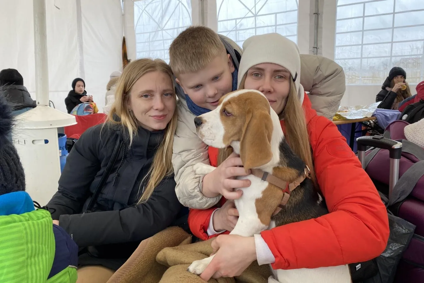 On 9 March 2022, in Medyka, southeast Poland, a family is photographed inside a tent set to host people who have crossed the border into Poland, fleeing the escalating conflict in Ukraine.