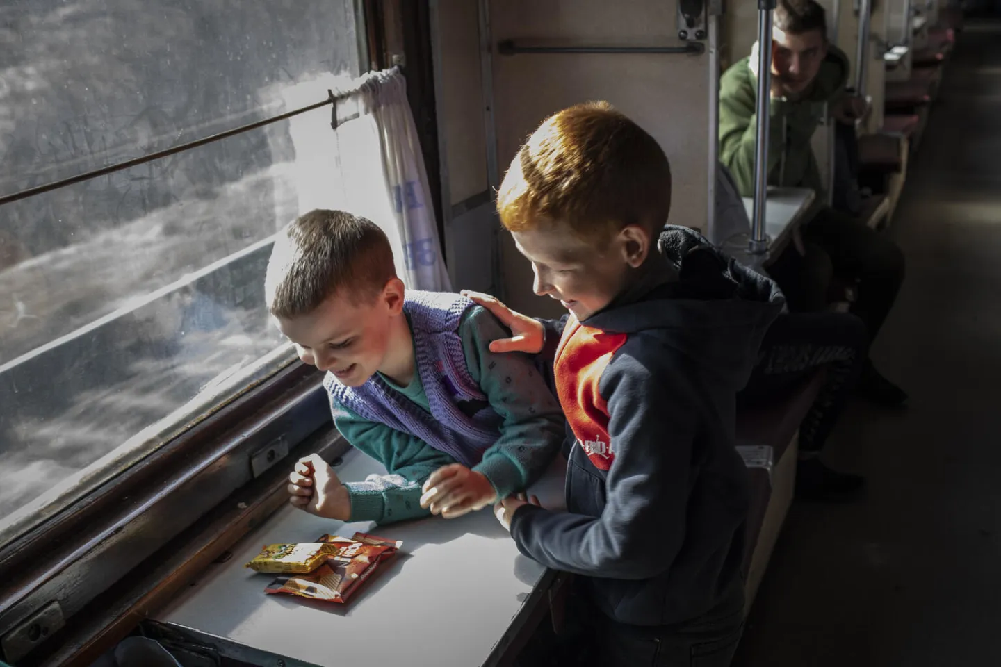 On 7 April 2022 in Ukraine, a group of relatives and family friends of women and children who have been separated from their husbands and fathers travel on an evacuation train that will take them to a safer part of the country, from the southern port city of Odesa toward the border with Poland.