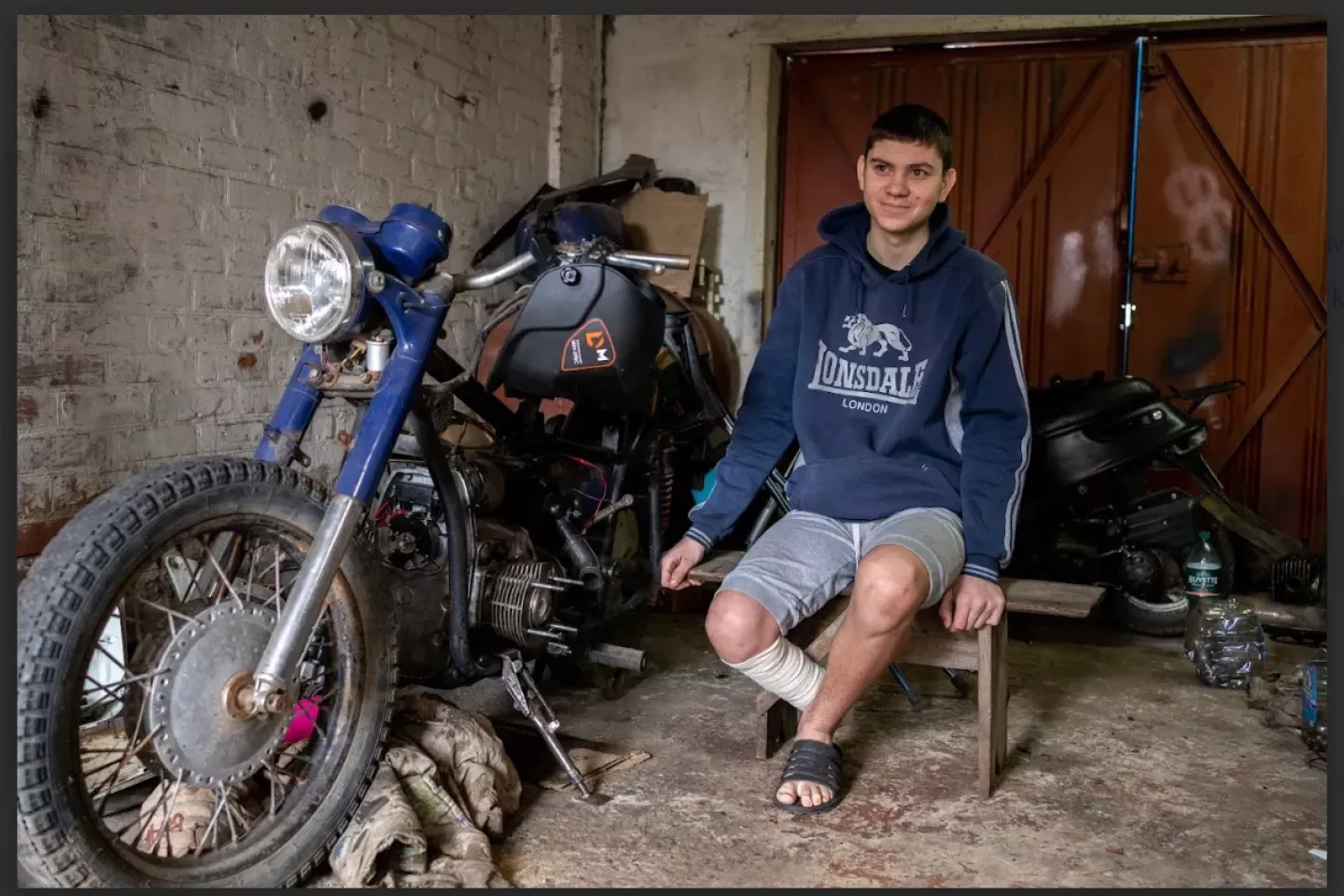 Yaroslav (14) is sitting next to his motorcycle