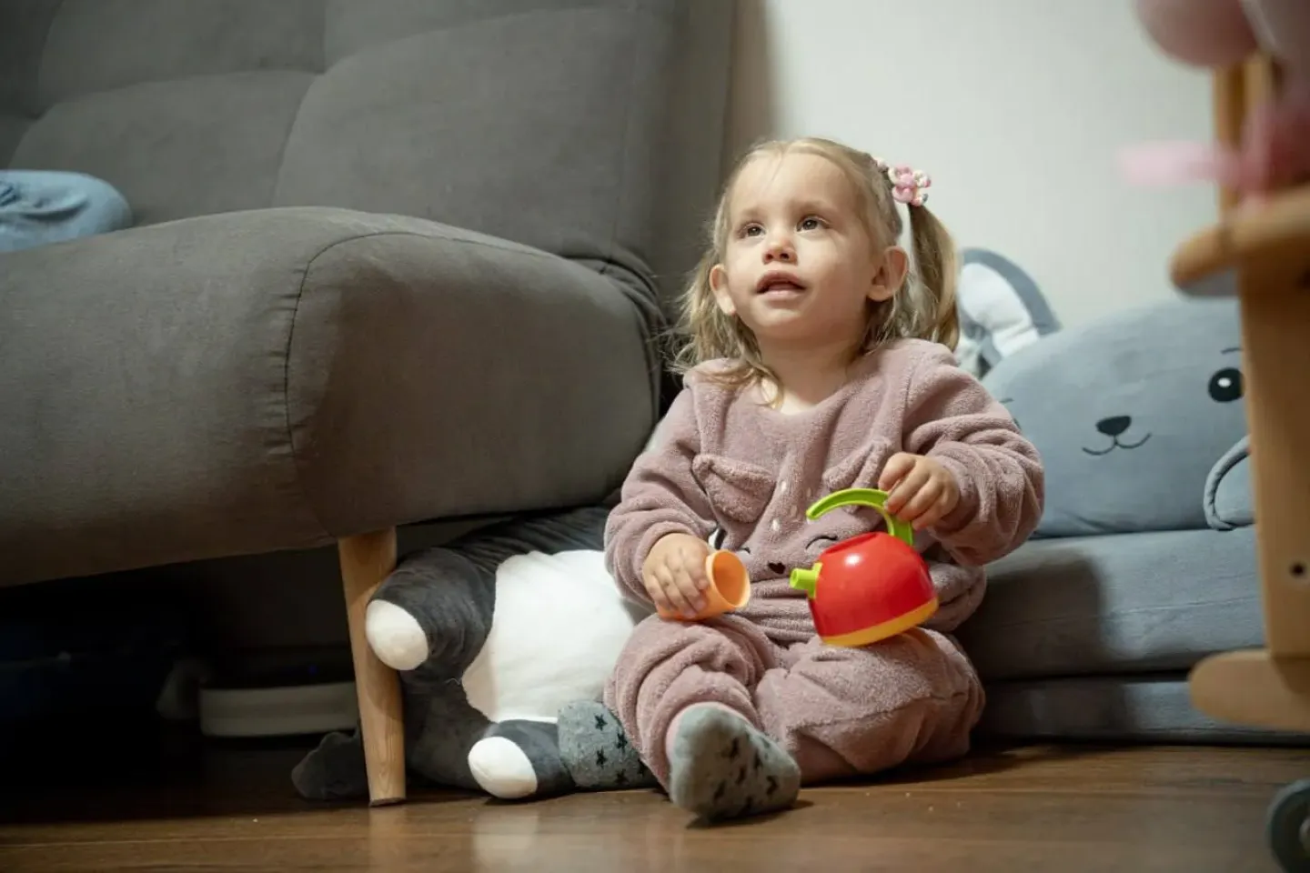Two-year-old Eva is playing with toys at home