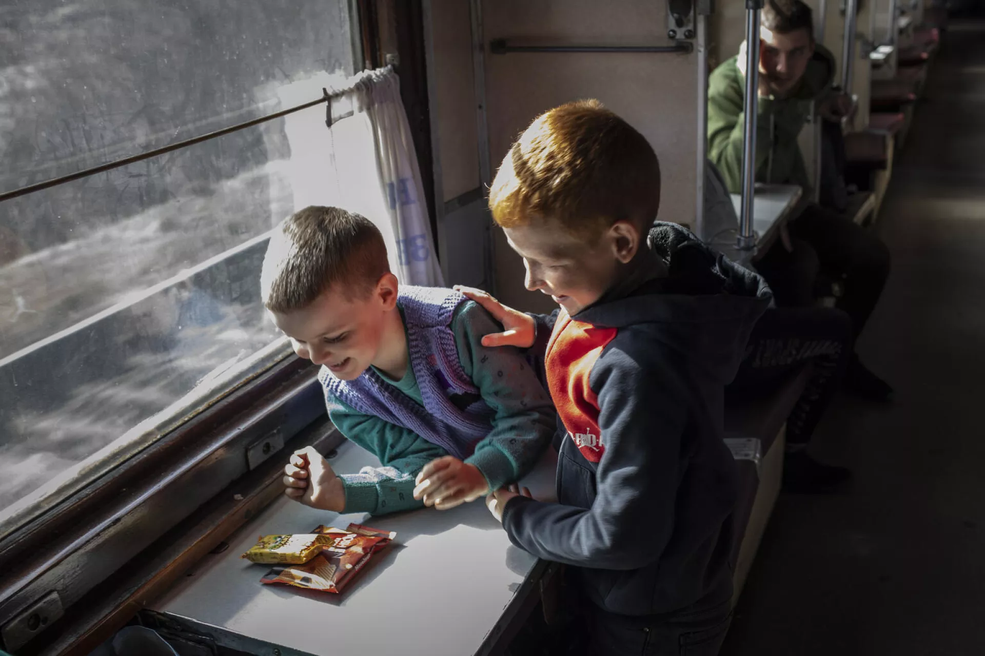 On 7 April 2022 in Ukraine, a group of relatives and family friends of women and children who have been separated from their husbands and fathers travel on an evacuation train that will take them to a safer part of the country, from the southern port city of Odesa toward the border with Poland.
