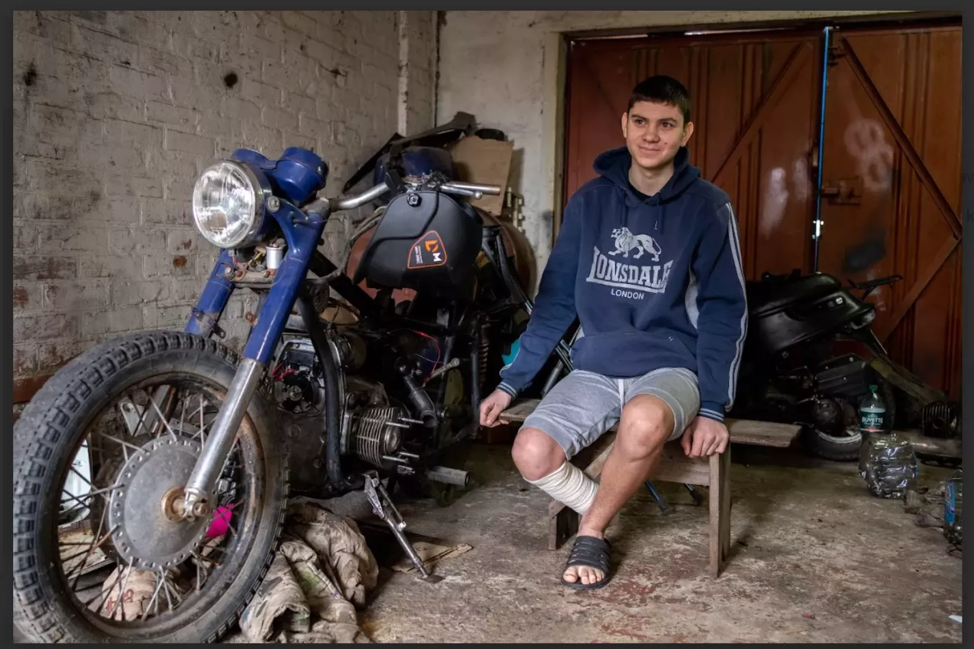Yaroslav (14) is sitting next to his motorcycle
