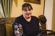 Foster parent Larysa Kirilina sits on a couch in her house.