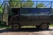 A Slovmiskvodokanal service vehicle covered with protective netting.