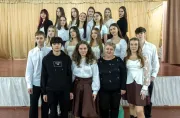 School students taking joint photo with their teacher.