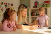 Kindergarten teacher with two small girls