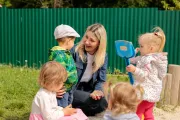 Kindergarten teacher with kids on the playground