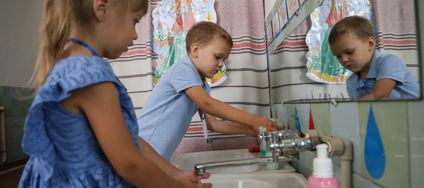 A photo of children washing hands