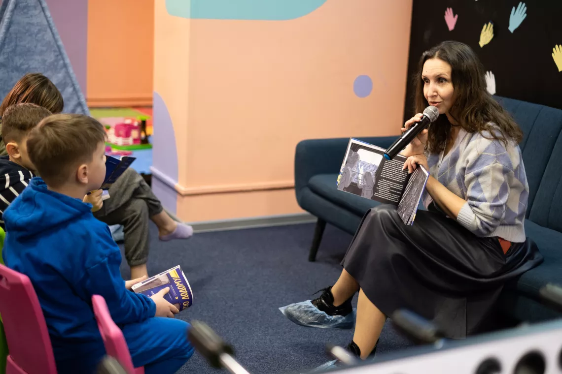 Children's writer Maryana Savka reads to children at the SPILNO child space