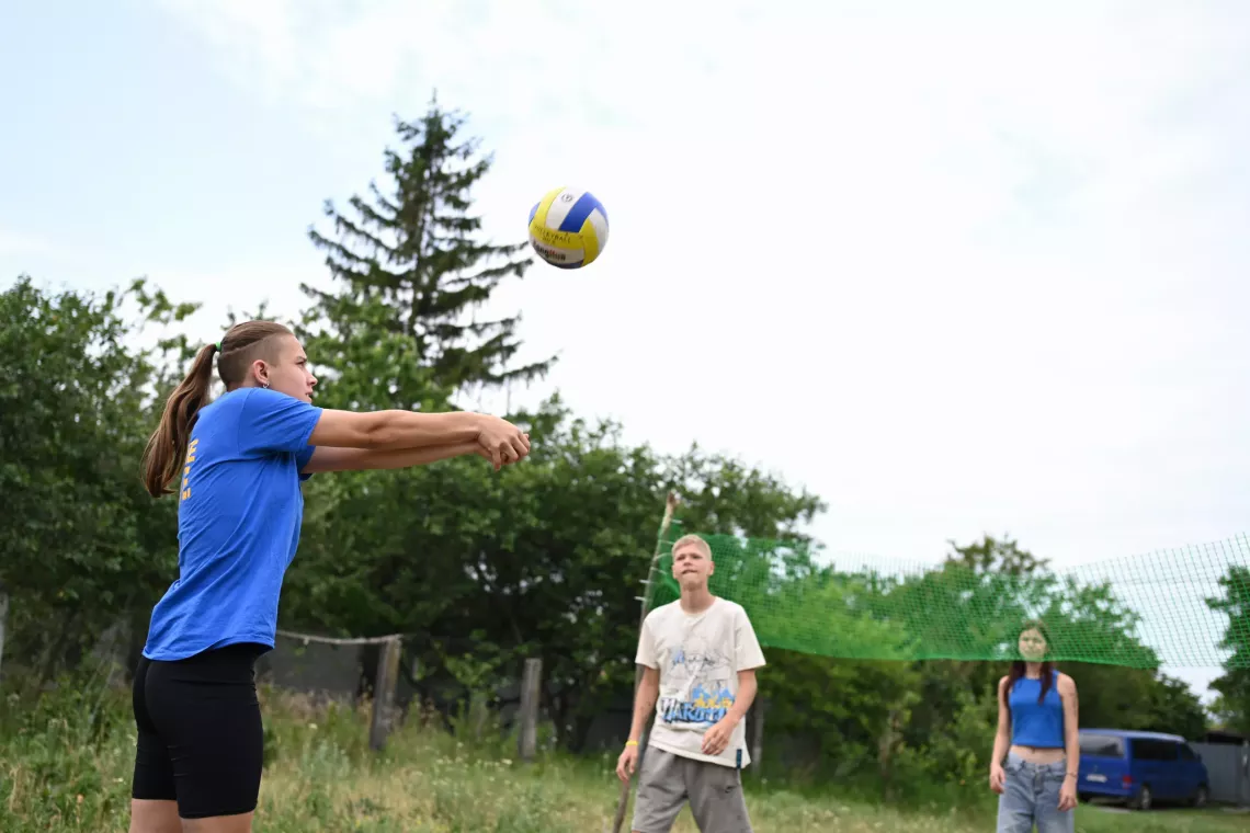 Teenagers playing volleyball