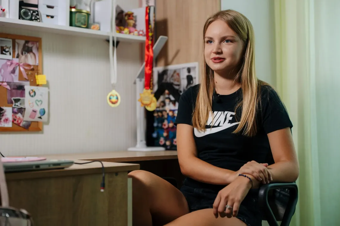 A girl sitting at her desk at home