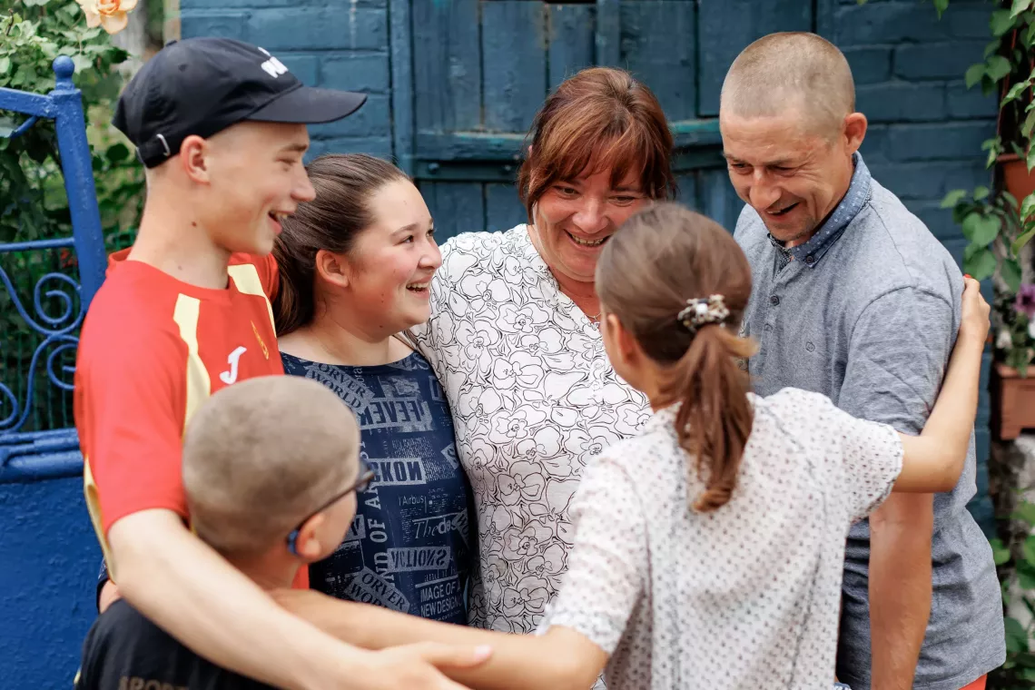 The family together with a 13-year-old girl (back to the camera), who came to them from a neighboring community.