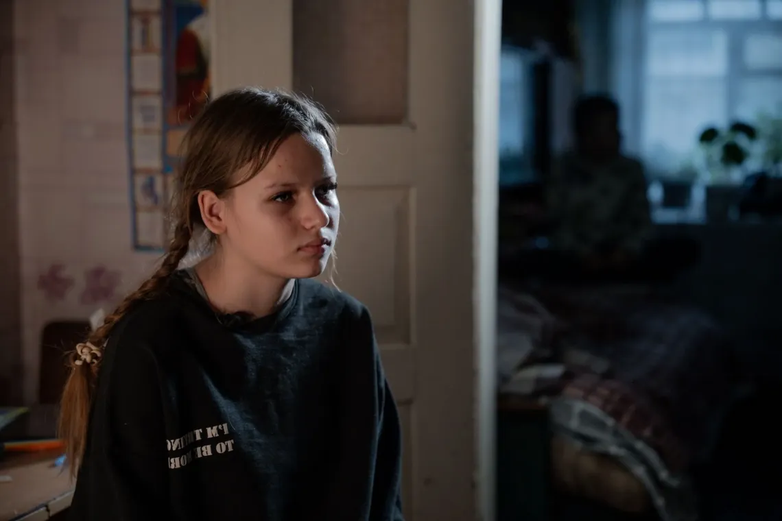 A girl sitting in her house, eastern Ukraine