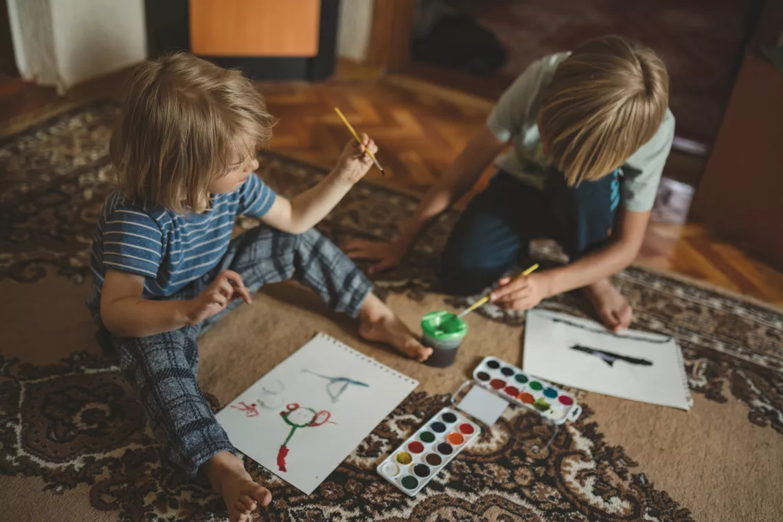 8-year-old Elvin and 3-year-old Leonard are playing and drawing at their temporary house in Khmelnytskyi region. The family used to have an apartment in Irpin, in a house, which is now half-destroyed. But when the war started they had to flee.
