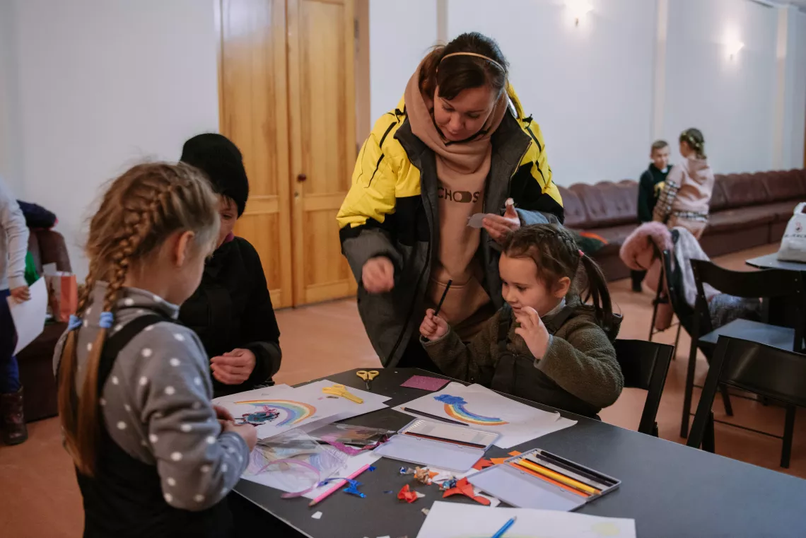 During an air raid, all children move to a safe space and continue playing