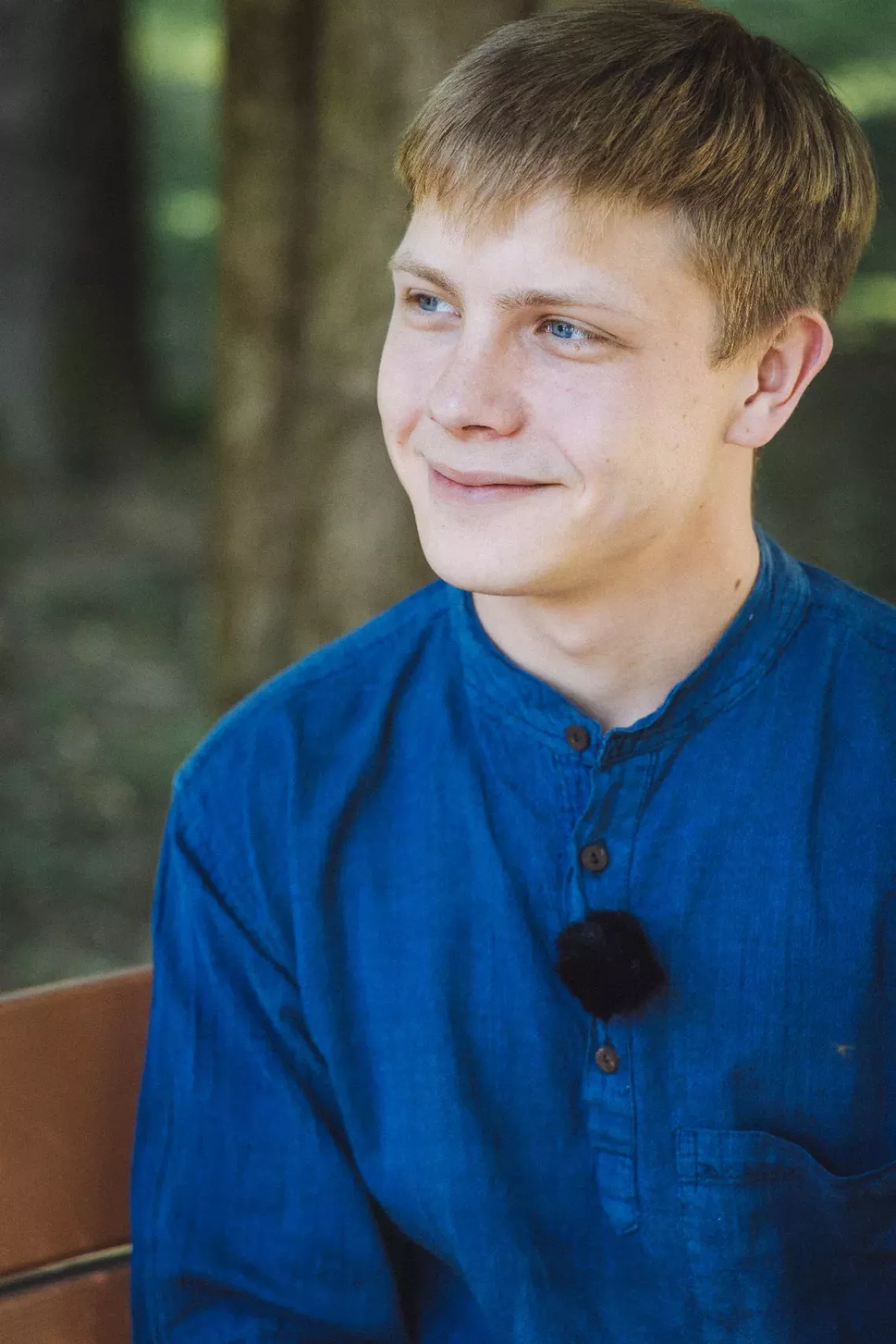 Viacheslav (21) rests in a park in Uzhhorod (Zakarpatska region, Ukraine) in June 2025. He was with his mother when she was killed in shelling in the Donetsk region in March 2022. Since the young man was an adult at the time, a court in Ukraine allowed him to become the official guardian of his four younger siblings. The family moved to a safe region, where Viacheslav found work and the children are doing well in school.
