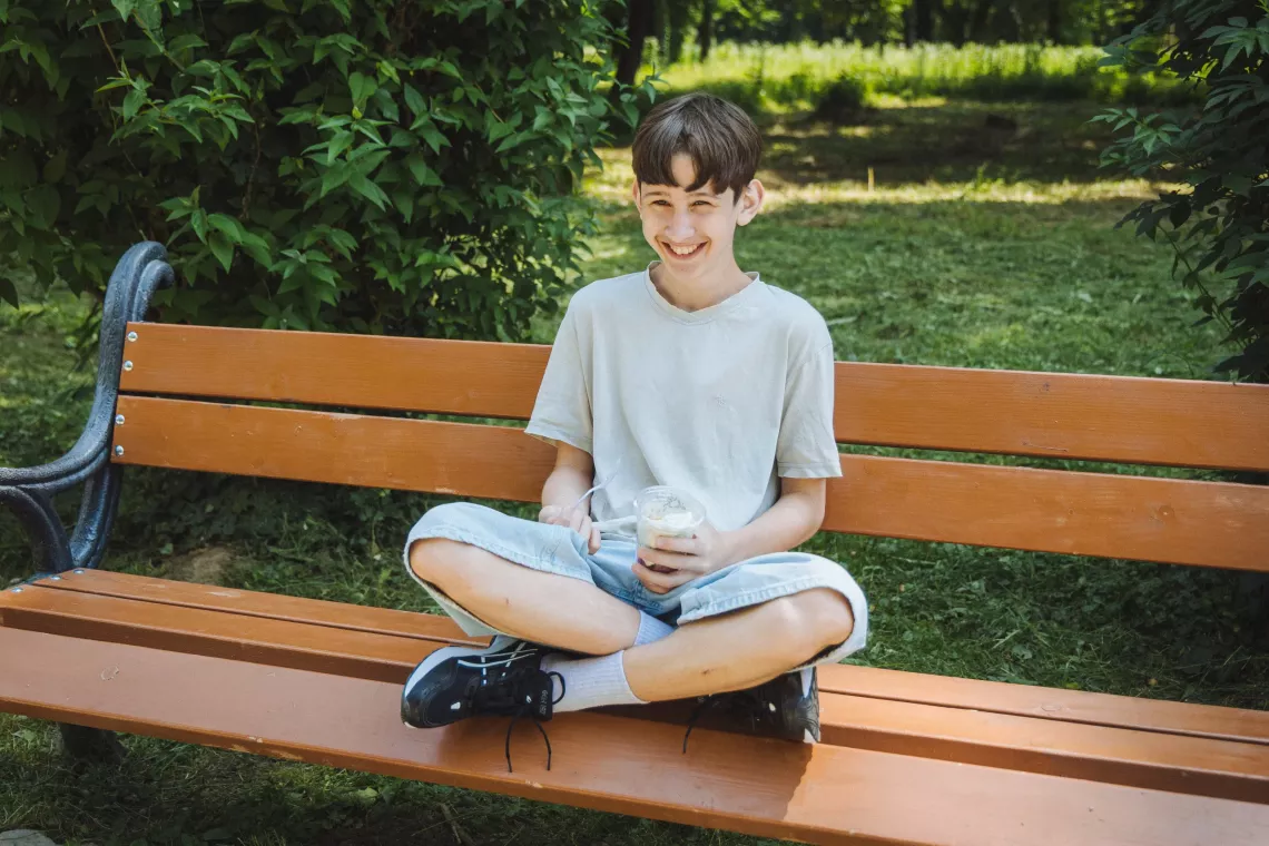 Tymur (13) spends time in a park in Uzhhorod (Transcarpathian region, Ukraine) in June 2025. The boy lost his mother as a result of shelling in March 2022 in the Donetsk region, so he and his siblings are currently being raised by his older brother Viacheslav (21).