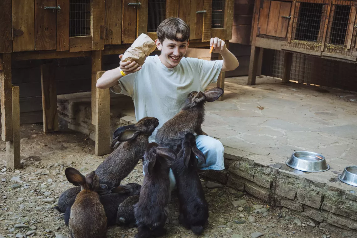 Tymur (13) feeds rabbits at the zoo