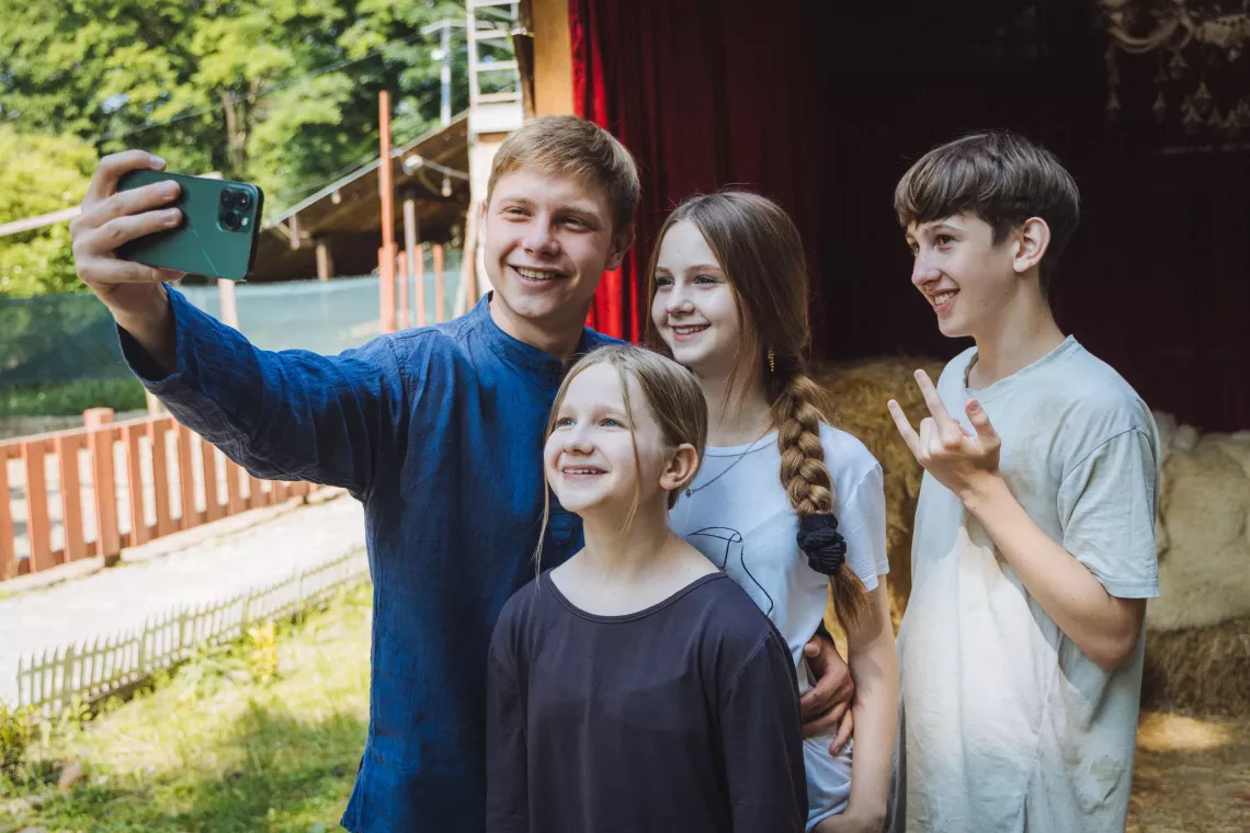 Viacheslav (21), Nicole (14), Tymur (13) and Olivia (11) take a selfie in Uzhhorod