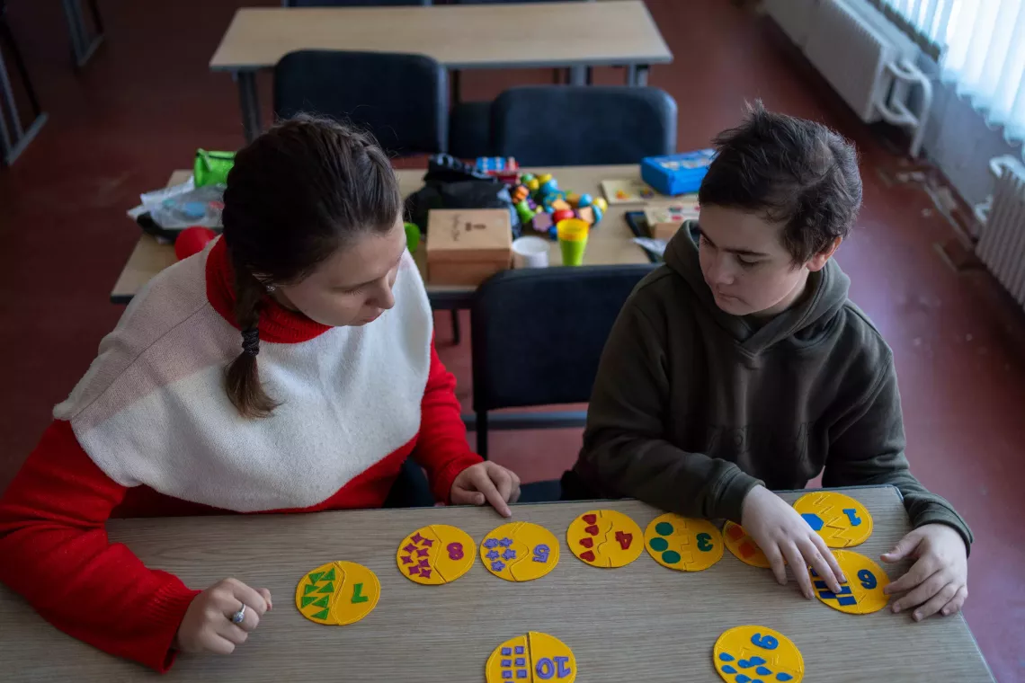 Tetiana, a child development teacher, during a lesson with a student