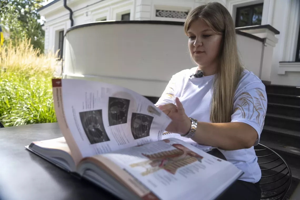 17-year-old Sofiia is leafing through a book
