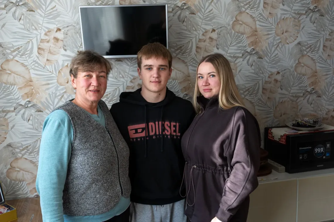 Teenage boy from Ukraine with his mother and grandmother