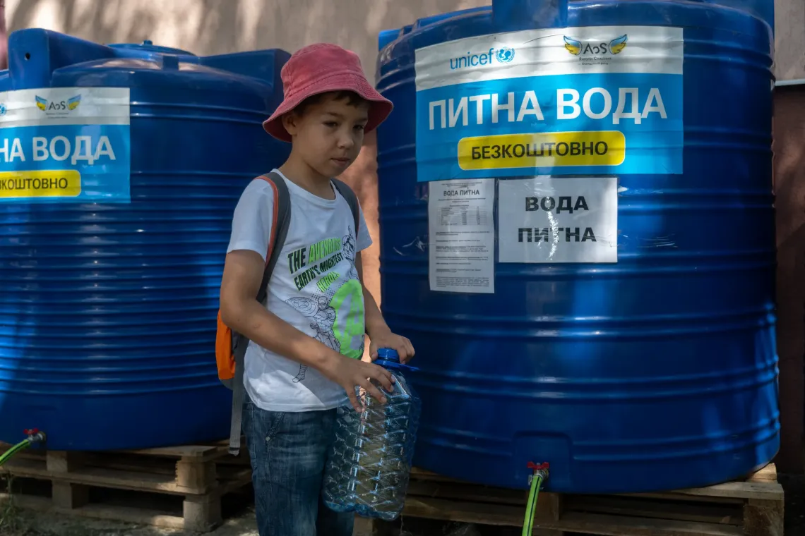 9-year-old Sashko collects water.