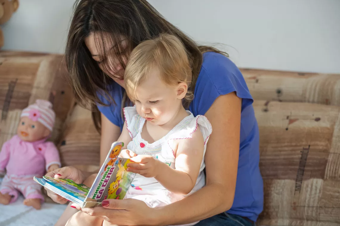 Mother is reading to her daughter.