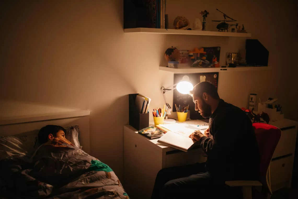 Father is reading a bedtime story to his son