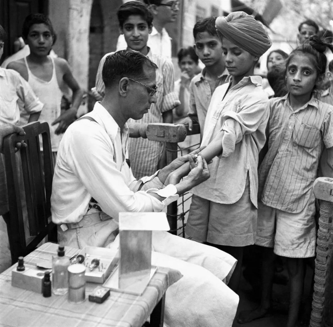 A doctor tests children for tuberculosis in New Delhi, India.