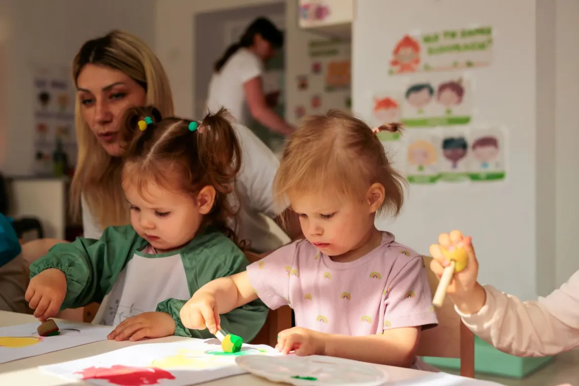 Toddlers at the painting class in their kindergarten
