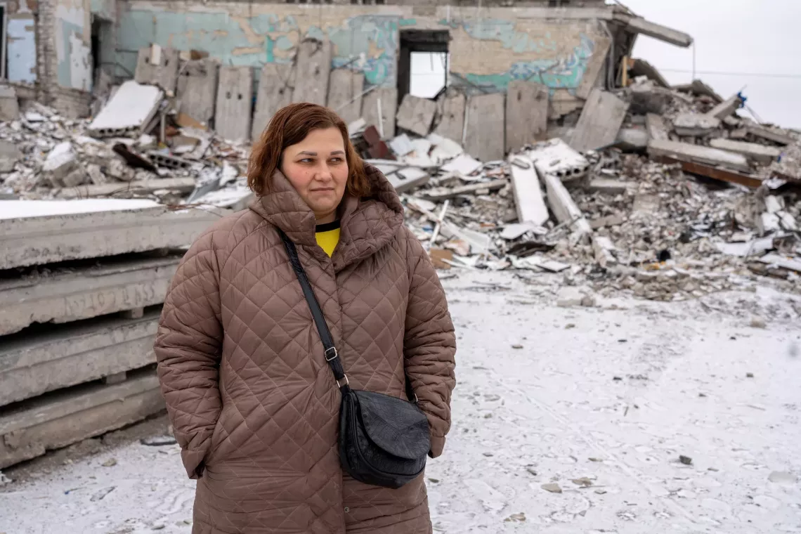 A woman stands in the cold in Ukraine