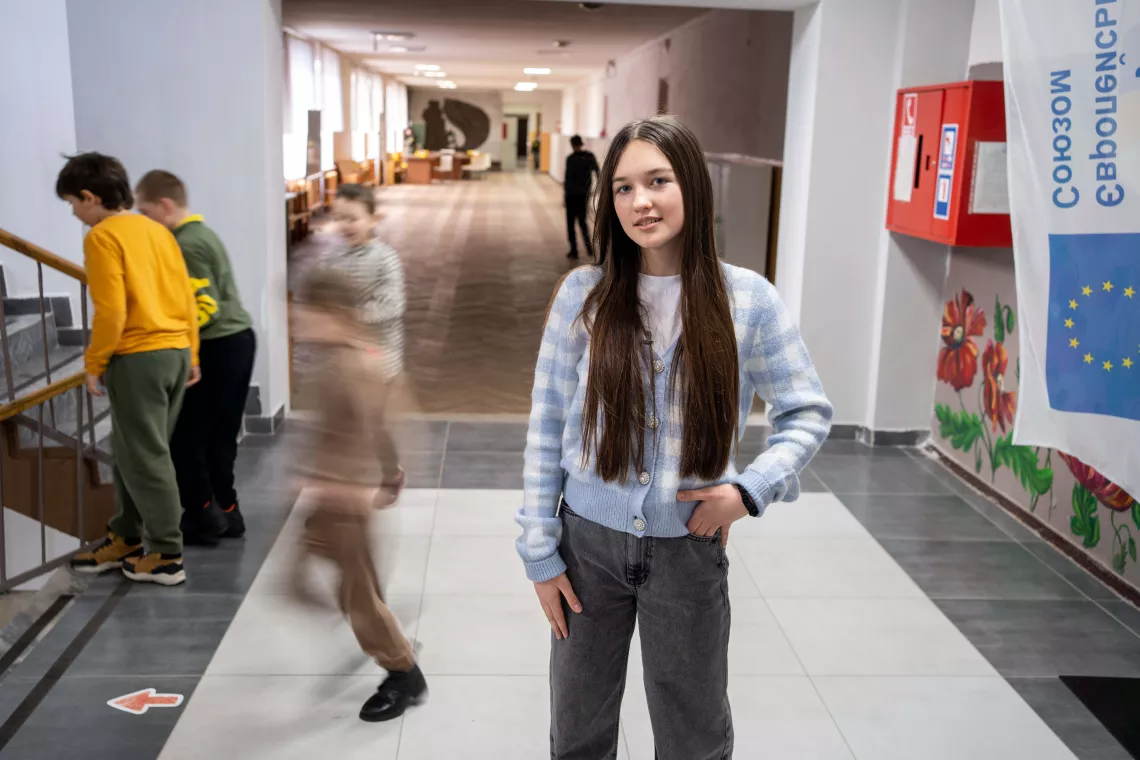 13-year-old Maria is standing in the hallway of her school, reconstructed after the shelling