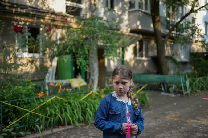 On 17 June 2024 in Poltava, a city in central Ukraine, seven-year old Amina stands in the street near her family&rsquo;s home following an attack that damaged buildings in the neighborhood and left dozens injured. Her family&rsquo;s apartment was damaged by the shockwave and her beloved cat went missing. &ldquo;We were very lucky not to be at home,&rdquo; said Amina&rsquo;s mother, Hanna, 32. &ldquo;There is no shelter in the building and nowhere to hide. People who were at home were injured; their legs were cut by shrapnel.&rdquo; 