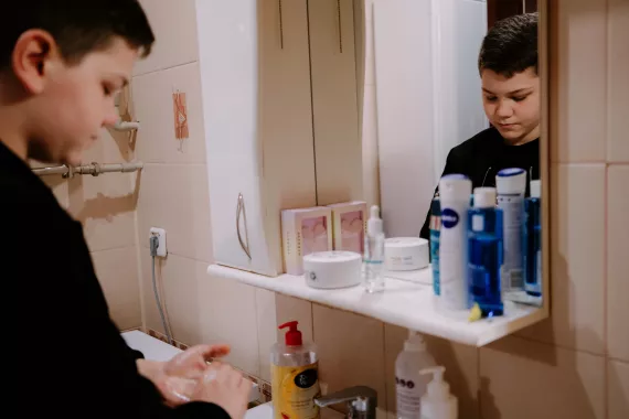 Mykhailo (12) washes his hands after a walk. The water that pours from the tap has unsatisfactory quality indicators, which negatively affects children's health