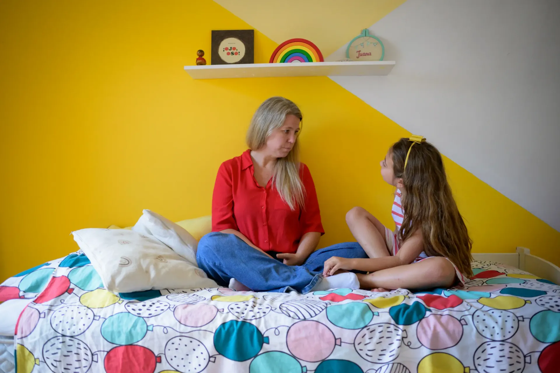 Madre e hija hablando en el cuarto
