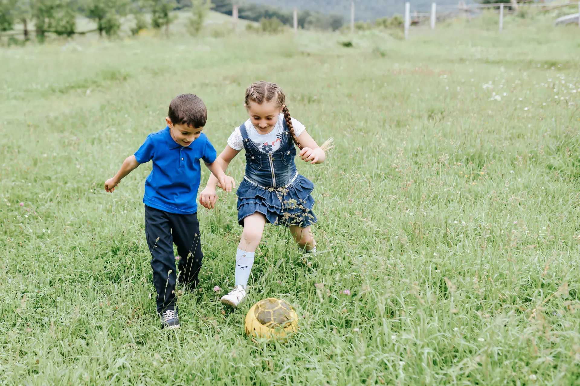 Ni&ntilde;o y ni&ntilde;a jugando a la pelota