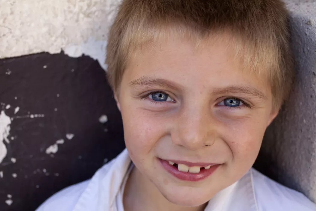 Ni&ntilde;o sonr&iacute;e y mira a c&aacute;mara