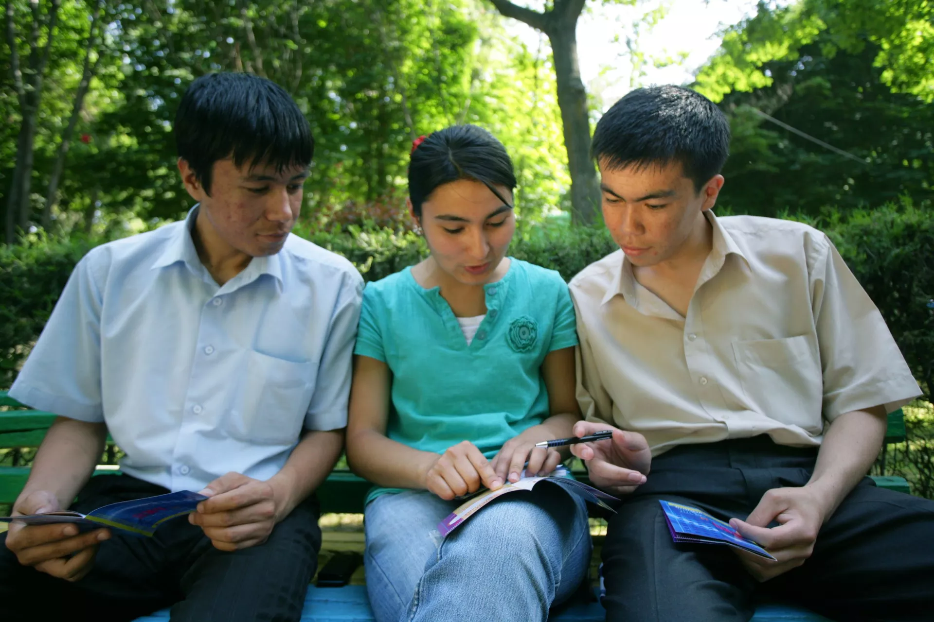 Young people looking at a pamphlet.